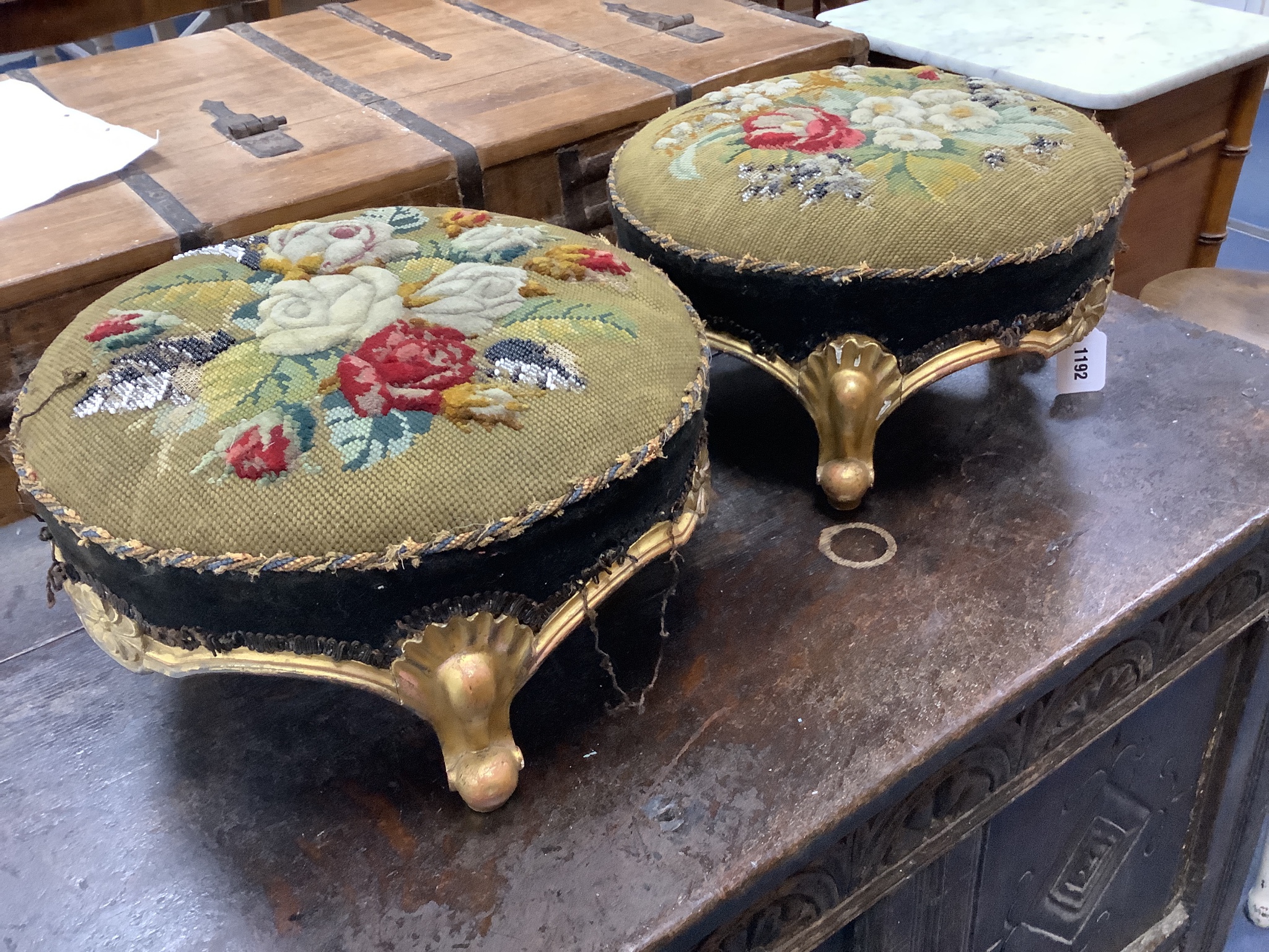 A pair of Victorian floral tapestry circular carved giltwood footstools, length 36cm, height 20cm
